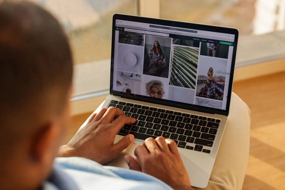 A diverse team collaborating on digital marketing strategies at a desk, using laptops and tablets.